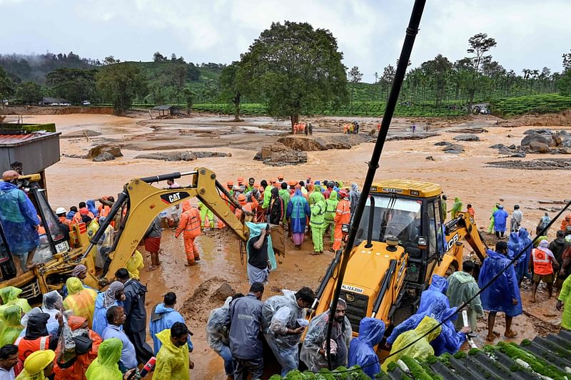 Relief personnel conduct a search and rescue operation at a site following landslides in Wayanad on 30 July, 2024. Landslides in India triggered by pounding monsoon rains struck tea plantations and killed at least 93 people on 30 July, with at least 250 others rescued from mud and debris, officials said